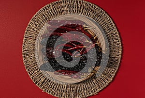 Dried Chilis on wood dish Red background Pasilla and Guajillo mexican spice photo