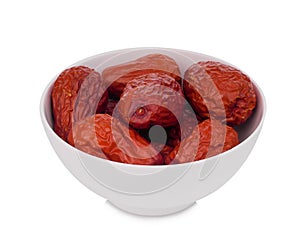 Dried chinese jujube or red date in the white bowl isolated