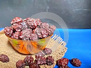 Dried chinese jujubes fruits ,chinese herbal medicine on bowl .