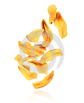 Dried chopped mango slices falling down, isolated on white background