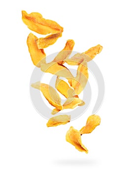 Dried chopped mango slices falling down on a white background