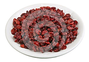 Dried Christmas cranberry berries on a white glass plate isolated