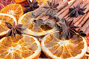 Dried citrus orange slices, Cinnamon sticks and Anise stars, background. Aromatic spices for Drink, cooking or baking.