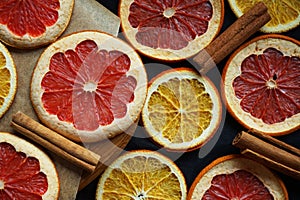 Dried citrus slices on a wooden board on a dark background
