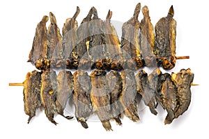 Dried clarias fishes in bamboo skewer