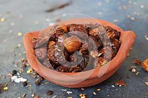 Dried coccinia grandis in the red clay pot. it is also know as Mithuku Vathal