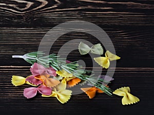 Dried colorful Italian pasta farfalle or bows with rosemary