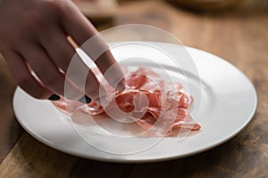 Dried coppa ham on white plate