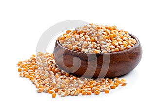 Dried corn kernels in wooden bowl isolated on white