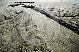 Dried creek with a pattern on the sand