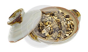 Dried dandelion root in a small bowl with lid