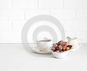 Dried dates and a cup of tea on white background. Copy space. Healthy breakfast concept