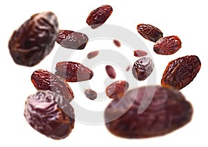 Dried dates levitate on a white background