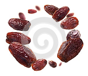 Dried dates levitate on a white background