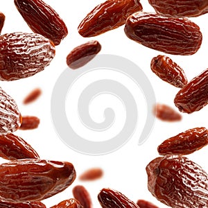 Dried dates levitate on a white background