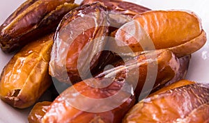 Dried dates on white plate