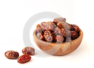 Dried dates in wooden bowl isolated on white