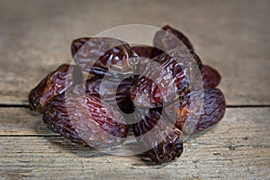 Dried dates on wooden table, sort medjool, sweet vegan superfruit