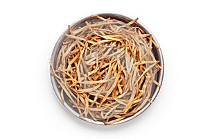 Dried daylily flower in a metal plate