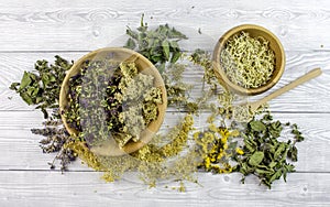 Dried different herbs on wooden background