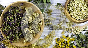 Dried different herbs on wooden background, macro image