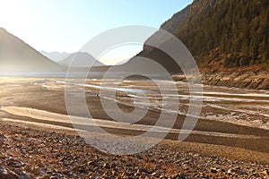 Dried earthen embankment dam during the renovation at Sylvenstein Reservoir, Germany