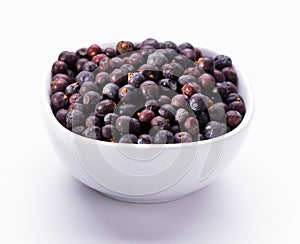 Dried elderberries in small white bowl