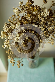 Dried field flowers bunch on a little table