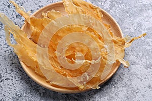 Dried fish maw on wooden table.