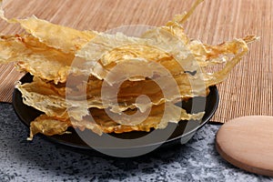 Dried fish maw on wooden table.