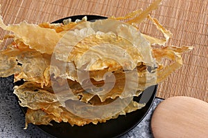 Dried fish maw on wooden table.
