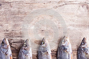 Dried fish on the old wood Board background
