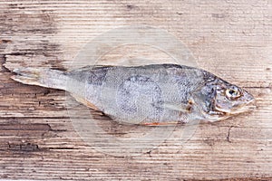 Dried fish on the old wood Board