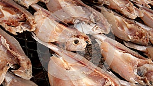 Dried fish on a rustic wooden surface