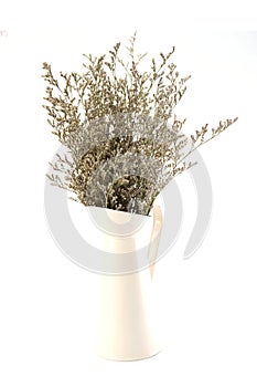 Dried flower bouquet in metal vase isolated on white background