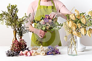 Dried flowers. Female florist arranging dried flowers into a beautiful bouquet. Sustainable floristry.