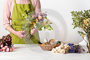 Dried flowers. Female florist arranging dried flowers into a beautiful bouquet. Sustainable floristry. photo