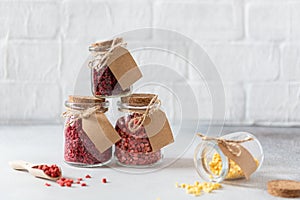 Dried freeze berries and fruits: strawberries, raspberries, cherry, banana, peach in glass jars on light background. Side view,