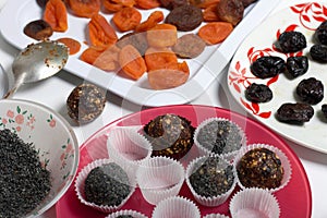 Dried fruit sweets. Balls of prunes, dates and coconut. With a sprinkle of black sesame powder