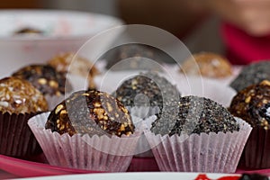 Dried fruit sweets. Balls of prunes, dates and coconut. With a sprinkle of black sesame powder