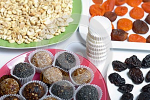 Dried fruit sweets. Balls of prunes, dates and coconut. With a sprinkle of black sesame powder