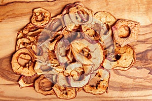 Dried fruits, apples, pear on wood background