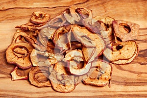 Dried fruits, apples, pear on wood background