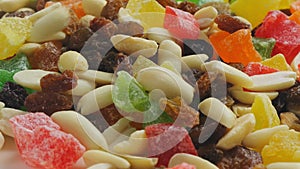 dried fruits candied fruits and nuts rotate in a circle on a wooden board