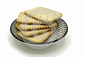 Dried fruits and digestive biscuits on a ceramic saucer isolated on white background. Energy and fiber natural source. Dieting photo