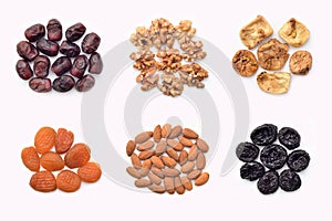 Dried fruits, fresh dates and nuts on the white background