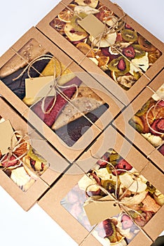 Dried fruits and fruit pastille in craft paper boxes with transparent lid