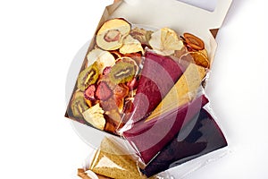 Dried fruits and fruit pastille in open craft paper box