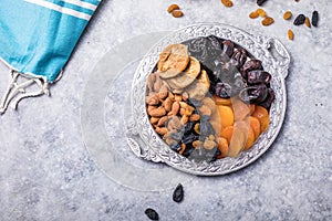 Dried fruits and nuts mix in a wooden bowl. Assortment of candied fruits. Judaic holiday Tu Bishvat. Copy space