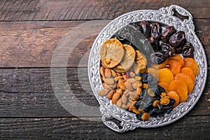 Dried fruits and nuts mix in a wooden bowl. Assortment of candied fruits. Judaic holiday Tu Bishvat. Copy space